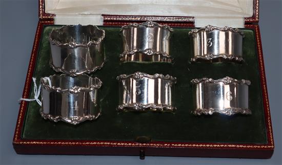 A cased set of six George V silver napkin rings, Elkington & Co, Birmingham, 1913, (numbered 1-6).